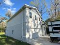 View of a two-story home with an attached garage, and driveway at 283 Wildwood Dr, New Smyrna Beach, FL 32168