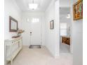 Bright foyer with tile flooring, console table, and doorway leading to a bedroom at 291 Northcote Ct, Deland, FL 32724