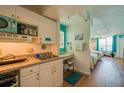 Fully equipped kitchenette offering modern appliances with a view to the bedroom at 313 S Atlantic Ave # 6140, Daytona Beach, FL 32118
