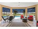 Beautiful enclosed patio with comfortable seating, ceiling fans, and views of the pool and golf course at 3432 Wise Way, The Villages, FL 32163