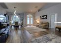 Inviting living room with vaulted ceiling, hardwood floors, and French doors leading to the outside at 36320 Piney Ridge Blvd, Fruitland Park, FL 34731