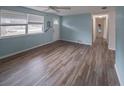 Open-concept living room with modern wood-look flooring and light blue walls at 412 Cherry St, South Daytona, FL 32119