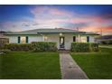 Well-kept single-story home featuring a lush green lawn and inviting front entrance at 445 Virginia Ave, St Cloud, FL 34769
