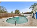 Backyard pool and patio surrounded by a wooden fence offering space for relaxation and outdoor entertaining at 445 Virginia Ave, St Cloud, FL 34769