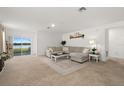 Spacious living room boasts natural light and outdoor access with comfortable seating and stylish decor at 515 Stowers Dr, New Smyrna Beach, FL 32168