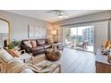 Inviting living room with modern furnishings, light wood floors, and sliding door access to balcony at 5300 S Atlantic Ave # 8-404, New Smyrna Beach, FL 32169