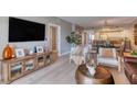 Bright and airy living room area showcasing stylish furnishings and open floorplan to the dining area at 5300 S Atlantic Ave # 8-404, New Smyrna Beach, FL 32169