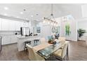 Bright kitchen with stainless steel appliances, white cabinets, and breakfast bar seating at 583 Lost Shaker Way, Daytona Beach, FL 32124