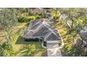 Aerial view of the home showcasing its landscaped yard, roof, and surrounding greenery at 5981 Jandon Ct, Port Orange, FL 32127