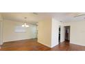 Bright living room boasts hardwood floors and a front door, complemented by natural light from the window at 685 E French Ave, Orange City, FL 32763