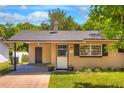 Inviting single-story home featuring a cozy front porch and well-maintained landscaping at 741 Greenway Pl, Daytona Beach, FL 32114