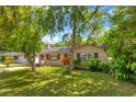 Charming single-story home with a well-kept lawn and mature landscaping, exuding curb appeal at 741 Greenway Pl, Daytona Beach, FL 32114
