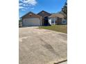Charming single-story home featuring a two-car garage, neutral paint, and a well-maintained front yard at 7879 Camlyn Ct, Orlando, FL 32818