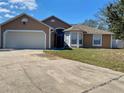 Charming single-story home featuring a two-car garage, neutral paint, and a well-maintained front yard at 7879 Camlyn Ct, Orlando, FL 32818