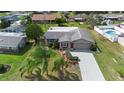 Aerial view of a well maintained home with a long driveway, mature landscaping and a private backyard pool at 826 W Gaucho Cir, Deltona, FL 32725