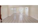 Neutral living room features tile flooring and ample natural light at 826 W Gaucho Cir, Deltona, FL 32725