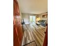 Cozy living room featuring wood floors and sliding glass doors at 1000 Lake Of The Woods Blvd # 104F, Casselberry, FL 32730