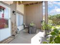 Inviting front porch with a cozy seating area, decorative plants, and a welcoming entrance with house number visible at 10477 Montpelier Cir, Orlando, FL 32821