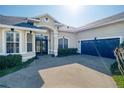 Attractive single-story home featuring a two-car garage, complemented by lush landscaping, and arched entryway at 1051 Dunbar Ave, Sanford, FL 32771