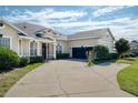 Attractive home featuring a spacious driveway leading to a two-car garage, complemented by lush landscaping at 1051 Dunbar Ave, Sanford, FL 32771