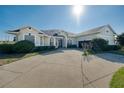 Beautiful single-story home showcasing a manicured lawn, long driveway, and attached two-car garage at 1051 Dunbar Ave, Sanford, FL 32771