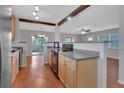 Kitchen featuring warm wood cabinets, granite countertops, and an open layout perfect for entertaining at 129 S Marydell Ave, Deland, FL 32720