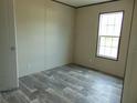 Cozy bedroom featuring a large window and modern flooring, perfect for relaxation at 1367 Vine St, Daytona Beach, FL 32117