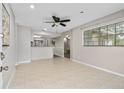 Open-concept living room with tile floors, ceiling fan, and view of dining area at 1702 Carolina Ave, Ormond Beach, FL 32174