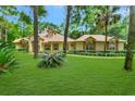 Well-maintained one-story home with lush lawn, mature trees, and beautiful landscaping at 1875 Glenwood Oaks Ln, Deland, FL 32720