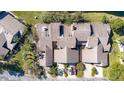 Overhead view of townhomes with lush greenery, a pond, and ample parking at 2015 Cornell Pl, Port Orange, FL 32128