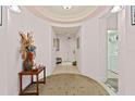 Inviting hallway featuring tiled floors, neutral paint, and an ornate rug creating a warm and welcoming space at 2515 S Atlantic Ave # 401, Daytona Beach Shores, FL 32118