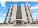 Striking exterior elevation of a tall condominium building with a glass facade and private balconies at 2555 S Atlantic Ave # 1007, Daytona Beach Shores, FL 32118