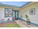 Covered entry features double doors, decorative accents, and landscaping at 2557 Shiprock Ct, Deltona, FL 32738