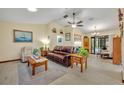 Comfortable living room featuring a ceiling fan, recliner, leather sofa, and light woodgrain floors at 2557 Shiprock Ct, Deltona, FL 32738