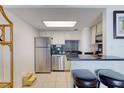 Well-equipped kitchen with stainless steel appliances, dark countertops and bar stool seating at 2700 Ocean Shore Blvd # 305, Ormond Beach, FL 32176