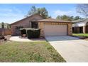 Well-maintained single-story home with a brick facade, two-car garage, and neatly trimmed front yard at 3021 Little Cypress Cv, Winter Park, FL 32792