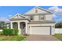 Charming two-story home featuring a well-maintained lawn, arched entry, and a spacious two-car garage at 3565 Fernanda Dr, Deltona, FL 32738