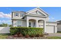 Charming two-story home with attractive landscaping, arched entry, and a two-car garage at 3565 Fernanda Dr, Deltona, FL 32738
