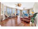 Bright living room features hardwood floors and sliding doors to a balcony at 4626 Harbour Village Blvd # 3302, Ponce Inlet, FL 32127