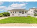 Two-story home featuring a spacious lawn with lush green grass at 4734 S Atlantic Ave, Ponce Inlet, FL 32127