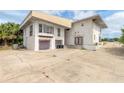 Two-car garage, featuring a spacious driveway and a lush green yard at 4734 S Atlantic Ave, Ponce Inlet, FL 32127