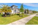Attractive single Gathering home with a green lawn and tropical landscaping at 6271 W Fallsgrove Ln, Port Orange, FL 32128