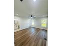 Bright bedroom features wood-look flooring, a ceiling fan, recessed lights, and an ensuite bathroom at 679 Rhodes Dr, Deland, FL 32720