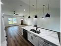 Modern kitchen features new stainless steel appliances, marble countertops, and an open floor plan at 679 Rhodes Dr, Deland, FL 32720
