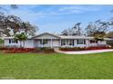 Inviting one-story home with manicured landscaping, walkway leading to the front entrance at 7108 East Rd, Lakeland, FL 33809