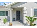 Inviting home entrance featuring a well-lit front door and lush landscaping at 755 Fairlawn Dr, Orange City, FL 32763