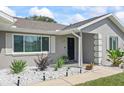 Charming front yard featuring decorative rock landscaping and a well-maintained walkway to the front door at 755 Fairlawn Dr, Orange City, FL 32763