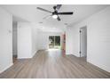 Bright living room featuring modern flooring, shiplap accent wall, recessed lighting, and sliding glass doors at 818 W Pennsylvania Ave, Deland, FL 32720
