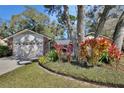 Attractive home exterior with a lovely landscaped garden and an attached two-car garage at 857 Westchester Dr, Deland, FL 32724