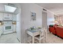 Cozy living space with white wainscotting and a connecting kitchen featuring matching appliances and wood counters at 935 Ocean Shore Blvd # 4010, Ormond Beach, FL 32176